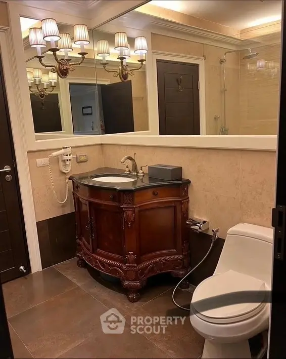 Elegant bathroom with vintage wooden vanity and modern fixtures in a luxurious home.