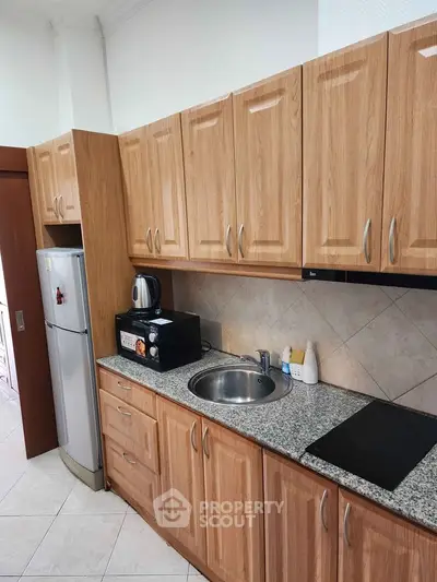 Modern kitchen with wooden cabinets and granite countertop