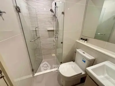 Modern bathroom with glass shower enclosure and sleek fixtures