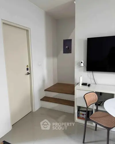 Modern interior with sleek TV setup and stylish furniture in a cozy living space.