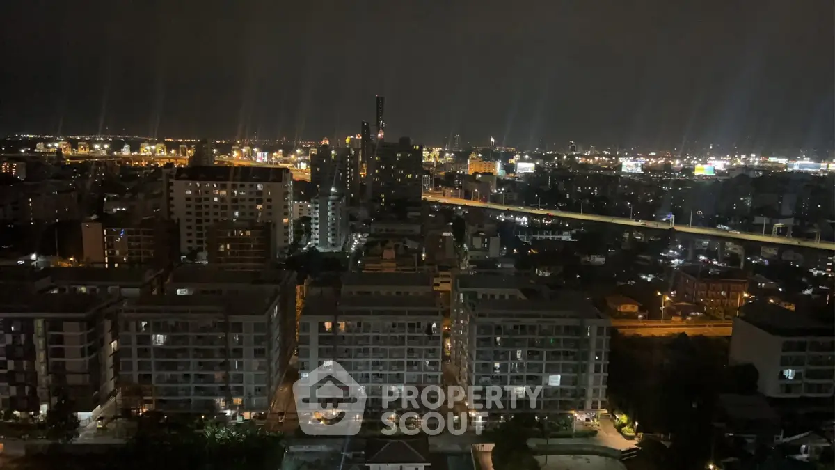 Stunning nighttime cityscape view from a high-rise building, showcasing vibrant city lights.