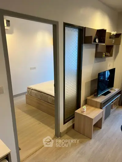 Modern apartment interior with cozy living room and bedroom, featuring stylish furniture and decor.