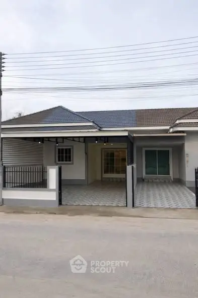 Charming single-story home with tiled driveway and modern facade in a serene neighborhood.