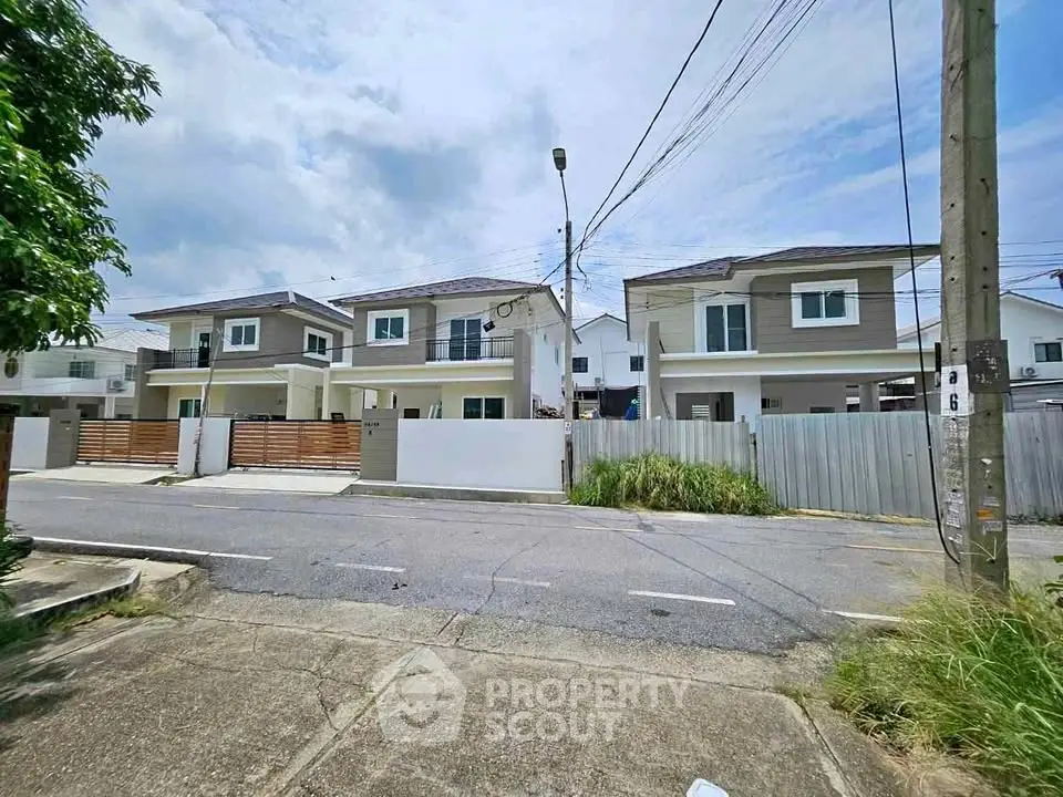 Modern suburban homes with sleek design and spacious driveways in a serene neighborhood.