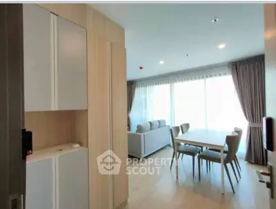 Spacious modern living room with dining area and large windows for natural light.