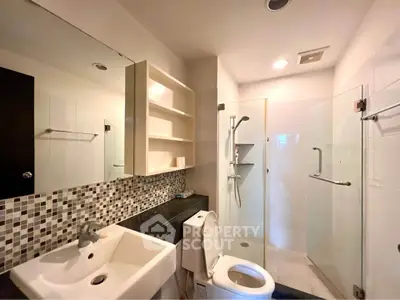Modern bathroom with glass shower and stylish tile backsplash