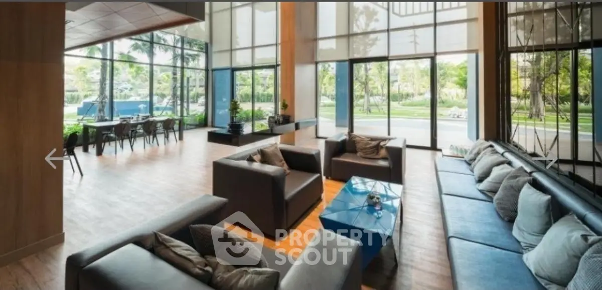 Spacious modern living room with large windows and garden view