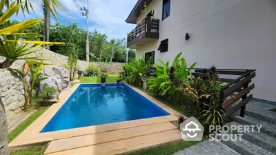 Stunning private pool with lush greenery and modern exterior design