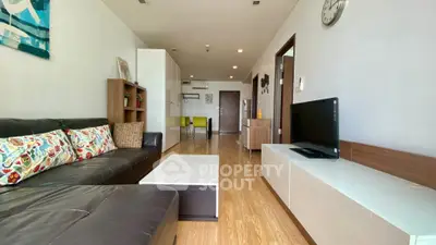 Spacious living room with modern decor and wooden flooring
