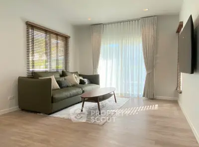 Modern living room with stylish sofa, large window, and elegant decor