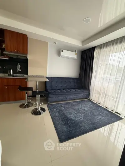 Modern living room with sleek furniture and large window for natural light.