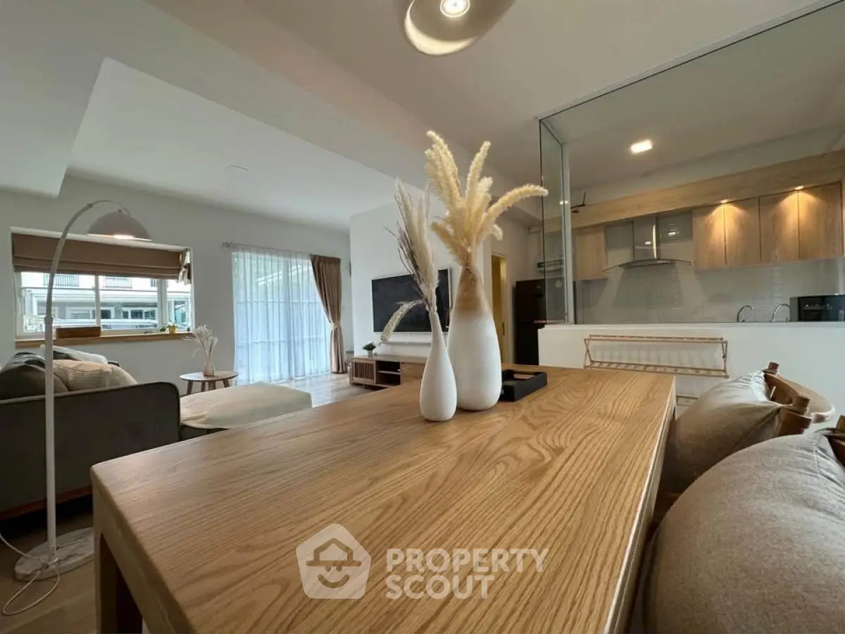 Spacious open-plan living room with modern decor and natural light