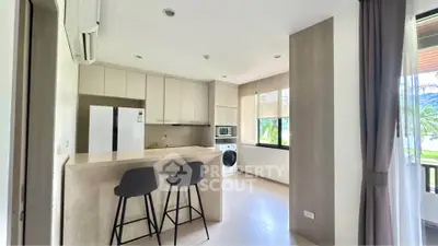 Modern kitchen with breakfast bar and appliances in bright open layout