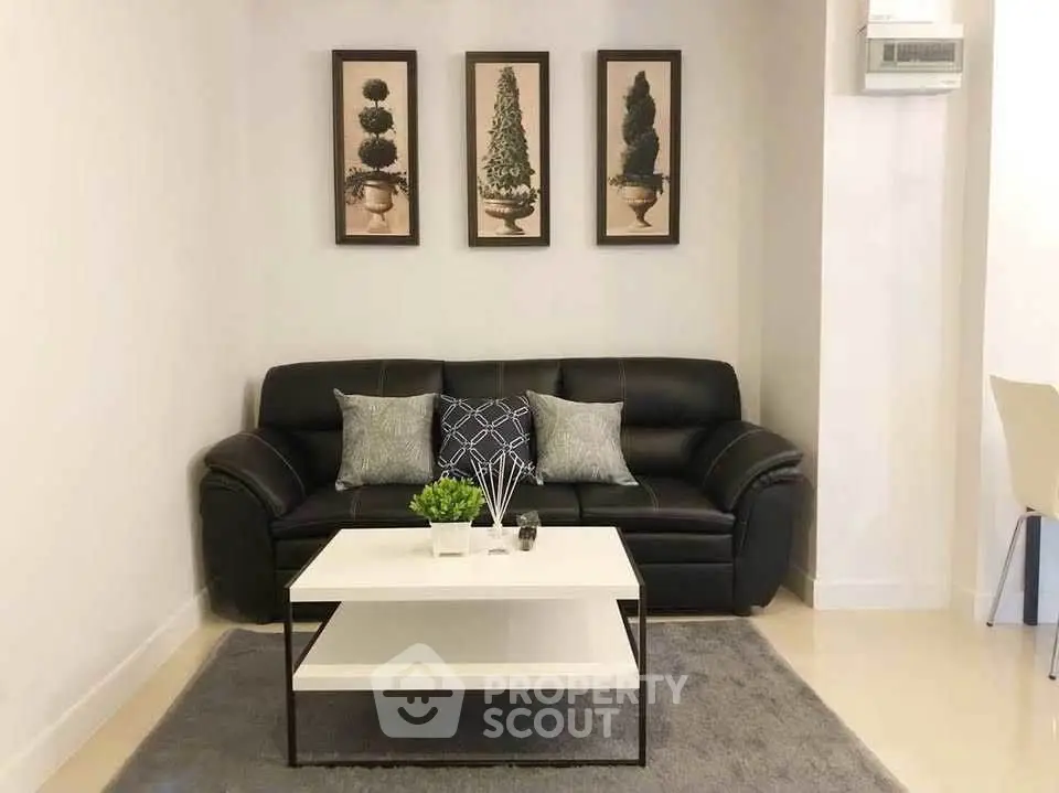 Stylish living room with black leather sofa and modern decor