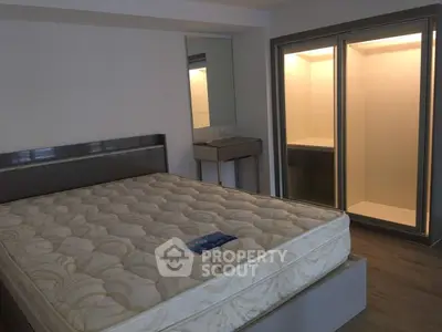 Modern bedroom with large bed and built-in closet