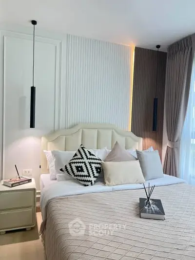 Elegant bedroom with modern decor, featuring a cozy bed, stylish lighting, and a serene ambiance.