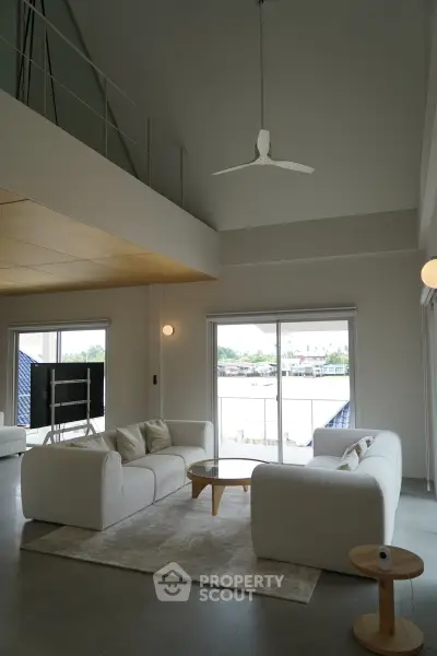 Spacious modern living room with high ceiling and elegant furniture
