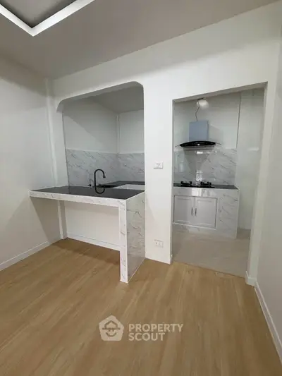 Modern kitchen with open layout and sleek marble countertops