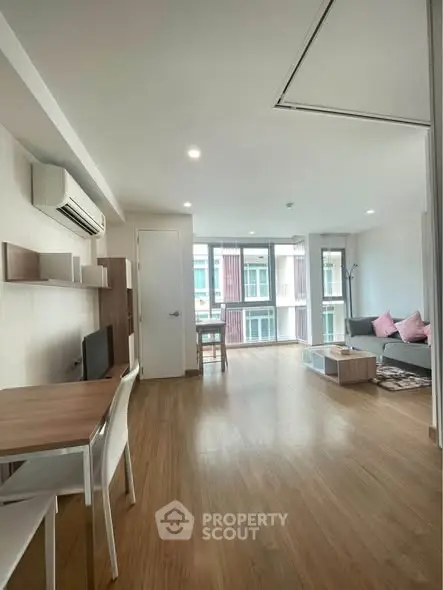 Spacious modern living room with natural light and stylish furnishings