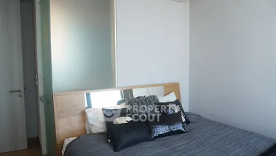 Modern bedroom with stylish decor and cozy bedding in a contemporary apartment.