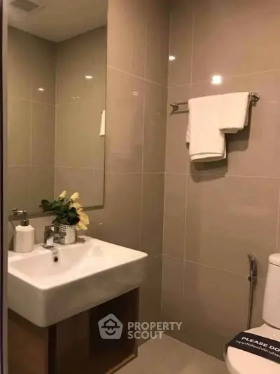Modern bathroom with sleek sink and elegant decor in a contemporary apartment.