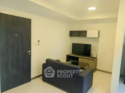Modern living room with sleek furniture and wall-mounted TV