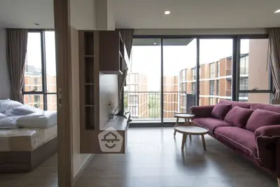 Modern living room with large windows and stylish furniture in a contemporary apartment.