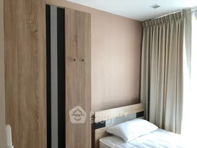 Cozy bedroom with modern wooden wardrobe and natural light