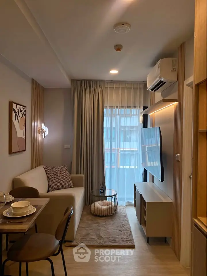 Modern living room with stylish decor and large TV, perfect for relaxation and entertainment.