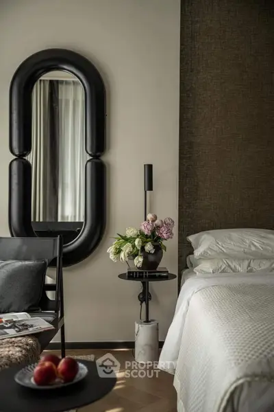 Luxurious bedroom with elegant decor and stylish mirror, perfect for modern living.