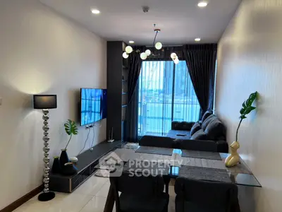 Modern living room with stylish decor and large windows offering natural light and city views.