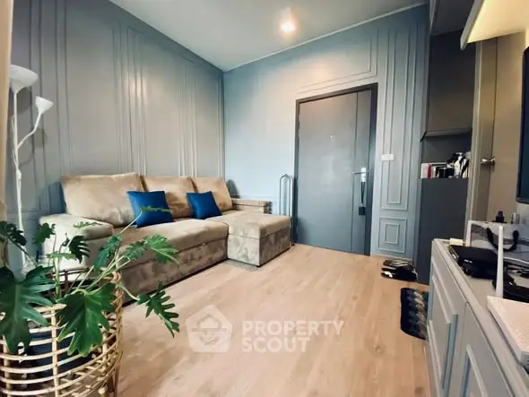 Stylish living room with modern decor and cozy seating in a contemporary apartment.