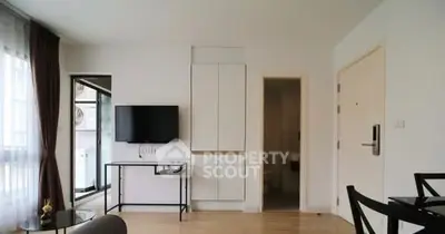 Modern living room with wall-mounted TV and sleek furniture
