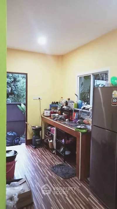 Cozy kitchen with modern appliances and wooden flooring, perfect for culinary enthusiasts.