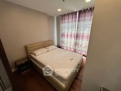 Cozy bedroom with double bed and elegant curtains in modern apartment