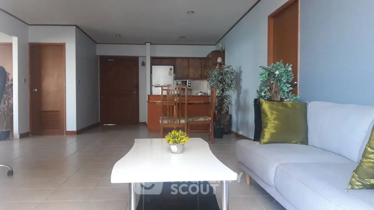 Spacious living room with modern decor and open kitchen layout