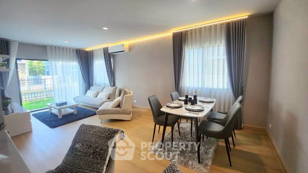 Spacious modern living room with elegant dining area and natural light