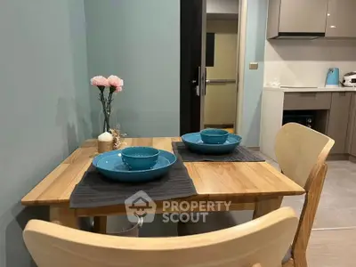 Cozy dining area with wooden table and modern kitchen in stylish apartment