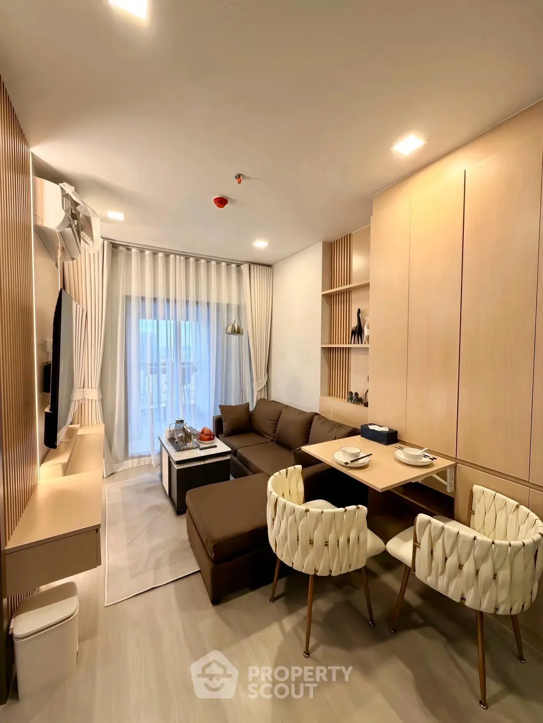 Modern living room with elegant decor and cozy seating area, perfect for relaxation and entertainment.