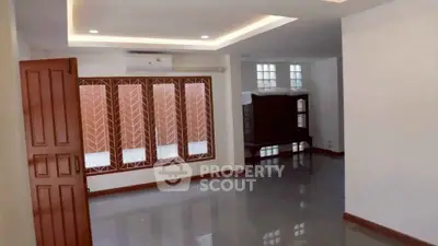 Spacious living room with modern design and large windows for natural light.
