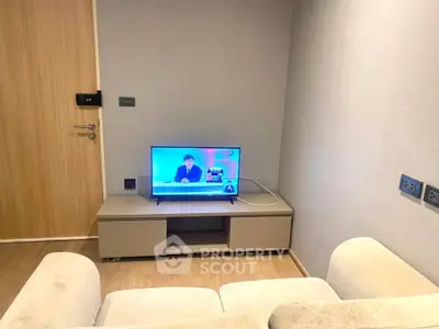 Cozy living room with modern TV setup and comfortable seating