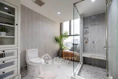 Luxurious modern bathroom with glass shower and city view
