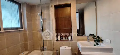 Modern bathroom with elegant fixtures and a glass-enclosed shower area.