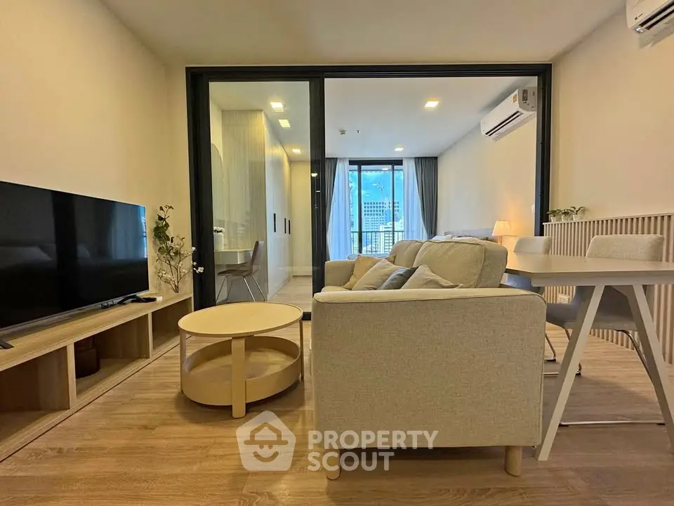 Modern living room with stylish furniture and city view, perfect for urban living.