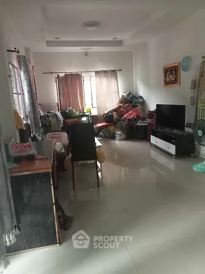 Spacious living room with modern decor and ample natural light, ideal for family gatherings.