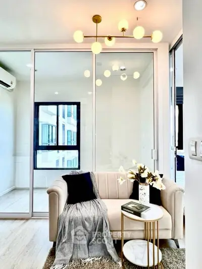Modern living room with elegant chandelier and cozy sofa in bright apartment