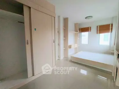 Spacious bedroom with built-in wardrobe and natural light