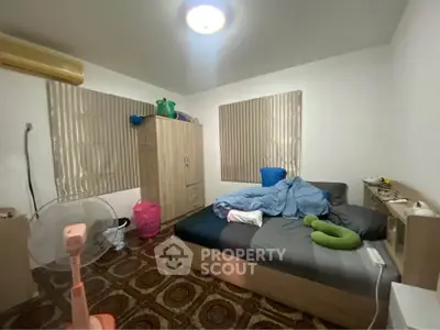 Cozy bedroom with modern furnishings and ample natural light, ideal for restful nights.