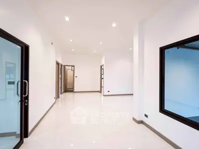 Spacious modern interior with large windows and sleek design, perfect for versatile living or office space.