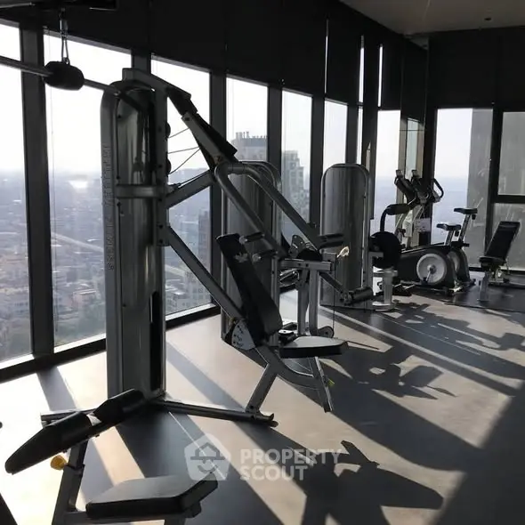 Modern gym with city view in luxury high-rise building